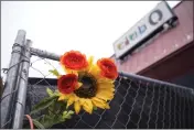  ?? DAVID ZALUBOWSKI — THE ASSOCIATED PRESS ?? A tribute is placed in a fence at Club Q in Colorado Springs, Colo., on Wednesday. It was the site of a mass shooting in November.