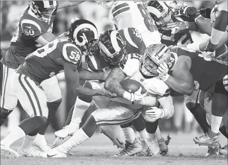  ?? Wally Skalij Los Angeles Times ?? LINEBACKER Cory Littleton, left, and the Rams’ defense made some big plays against Ezekiel Elliott all night, holding the Cowboys’ tailback to 47 yards in 20 carries. Elliott was stopped on fourth down on the first play of the fourth quarter.