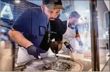  ?? DAMON HIGGINS / THE PALM BEACH POST ?? Nico Ravecca makes Thai rolled ice cream at Crema inside Grandview Public Market in West Palm Beach.