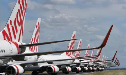  ??  ?? Virgin Australia aircraft parked at Brisbane airport. The airline went into a trading halt on Tuesday after a report it had hired a corporate turnaround expert. Photograph: Darren England/AAP