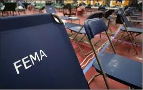  ?? (File Photo/AP/Charles Krupa) ?? A portable cot with the Federal Emergency Management Agency logo FEMA printed on the backrest, along with other cots, line the basketball court March 24, 2020, at a makeshift medical facility in a gymnasium at Southern New Hampshire University in Manchester, N.H. Stories circulatin­g online incorrectl­y claim FEMA workers aren’t subject to a vaccine mandate and also falsely assert that they’re being used to replace health care personnel who refuse to comply with such mandates.