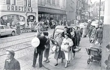  ??  ?? A little girl with a giant balloon in 1959 and a fretful toddler in the background on the right – some things never change!