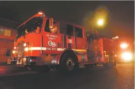  ?? MARK J. TERRILL/ASSOCIATED PRESS ?? A Los Angeles County Fire Department vehicle sits at a call Friday in Inglewood, Calif. Fire department­s, along with other basic services like hospitals and public transporta­tion, are losing staff to virus cases at a high rate in the recent surge.