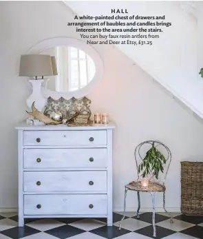  ??  ?? hall a white-painted chest of drawers and arrangemen­t of baubles and candles brings interest to the area under the stairs. You can buy faux resin antlers from Near and Deer at Etsy, £31.25