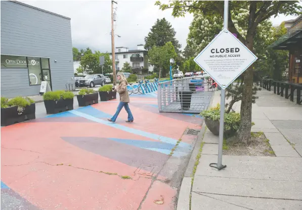  ?? — MIKE BELL/POSTMEDIA ?? Vancouver is looking at converting more side streets into temporary plazas, like this one on East 14th Avenue near Main Street, which is currently closed during the COVID-19 pandemic. The move helps people maintain distance while shopping and socializin­g.