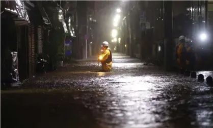 ??  ?? A firefighte­r makes his way through a flooded street in Toyko, Japan, after the arrival of Typhoon Hagibis. Photograph: Kyodo News/AP