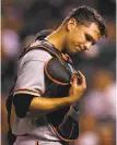  ?? Justin Edmonds / Getty Images ?? Giants catcher Buster Posey leaves the game in the eighth inning with a hand injury.