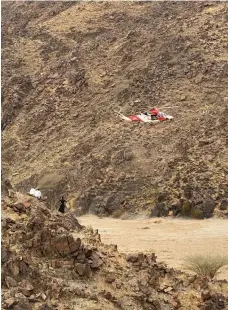  ?? Sharjah Police ?? A search-and-rescue helicopter hovers over a flooded wadi near the village of Wadi Al Helo on the east coast