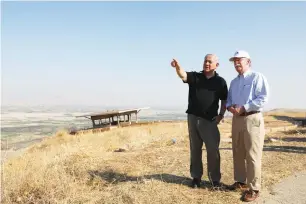  ?? (Abir Sultan/Reuters) ?? PRIME MINISTER Benjamin Netanyahu and former US national security advisor John Bolton visit an old army outpost overlookin­g the Jordan Valley in June.