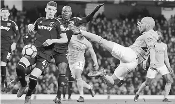  ??  ?? David Silva (right) leaps into the air to strike their second goal during the English Premier League football match between Manchester City and West Ham United at the Etihad Stadium in Manchester, north west England. — AFP photo