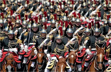  ?? AP ?? France’s Republican Guard rides down the Champs-Elysees avenue during the Bastille Day parade.