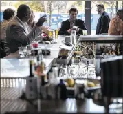  ?? TAMIR KALIFA / FOR AMERICAN-STATESMAN ?? Bartenders in Austin, such as at Corner’s patio bar at the JW Marriott hotel, poured almost $57 million in beer, wine and mixed drinks last month, according to the state comptrolle­r’s office.
