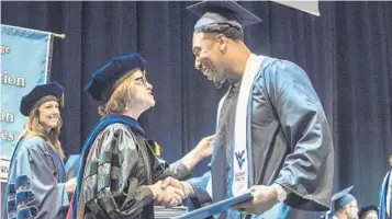  ?? BRIAN PERSINGER/ASSOCIATED PRESS ?? Raiders defensive end Bruce Irvin joyously accepts his degree from West Virginia University in May. Irvin, a former high school dropout who served time in jail, is as proud of his degree as he is the millions of dollars he’s made in the NFL.