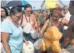  ?? RICK JERVIS, USA TODAY ?? Residents of Arecibo, Puerto Rico, line up Saturday to siphon drinking water from a fire hose.