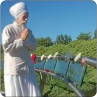  ??  ?? Mahan Rishi Singh Khalsa says prayers at the garden.