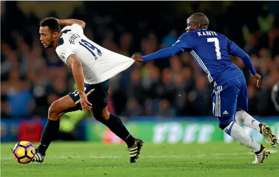 ?? PHOTO: GETTY IMAGES ?? Chelsea midfielder N’golo Kante clings to the shirt of Tottenham’s Mousa Dembele during the Premier League match in London yesterday.