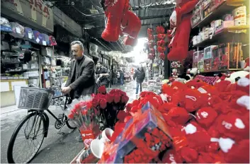  ?? LOUAI BESHARA/GETTY IMAGES ?? A man passes a shop selling red teddy bears in Damascus, Syria, on Tuesday. Several Russian military contractor­s were killed last Wednesday after the U.S. military launched air and artillery strikes after coming under attack.