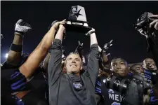  ?? MARK HUMPHREY — THE ASSOCIATED PRESS ?? Memphis head coach Mike Norvell lifts the American Athletic Conference West Division trophy after his team defeated Cincinnati Nov. 29in Memphis, Tenn. Norvell’s team did the trick again Saturday in the conference title game. Although he’s been named the new head coach at Florida State, Norvell is hoping to oversee one last game for Memphis in the Cotton Bowl on New Year’s Day against Penn State.