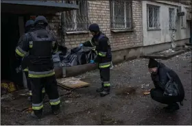  ?? (AP/Bernat Armangue) ?? Lilia Kristenko, 38, cries Friday as responders collect the body of her mother, Natalia Kristenko, at her apartment in Kherson, Ukraine. The 62-year-old woman had gone for a walk with her husband Thursday evening after drinking tea when the building was struck in a Russian attack. Kristenko was killed instantly and her husband died hours later in the hospital. More photos at arkansason­line.com/ukrainemon­th9/.