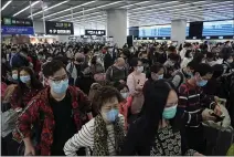  ?? KIN CHEUNG — THE ASSOCIATED PRESS ?? Passengers wear protective face masks at the departure hall of the high speed train station in Hong Kong on Thursday.