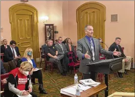  ?? ANDREW WELSH-HUGGINS / AP ?? Columbus police Commander Bob Meader testifies against a bill that would set a minimum level of training for armed school staff but also allow districts to require more training. The bill is meant to override a state Supreme Court ruling, which interprete­d current law to require armed teachers would need the same training as police.