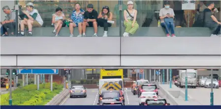  ?? Photo: Jelly Tse ?? Sitting above the traffic in IFC Mall is one way to keep out of the heat.