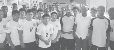  ??  ?? Walter Moore and Guyana Football Federation president Wayne Forde along with members of the National U17 squad.