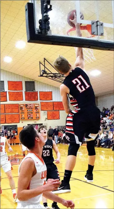  ?? Staff photograph by Mike Eckels ?? Junior Blackhawk Nick Coble, No. 21, slam dunks the basketball during the first quarter of the Gravette-Pea Ridge contest in Lion Fieldhouse at Gravette Jan. 6.