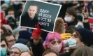  ?? Photograph: Valery Sharifulin/Tass ?? A man holds a portrait of Alexei Navalny at a rally in Moscow.