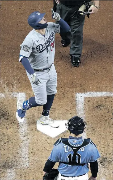  ?? Robert Gauthier Los Angeles Times ?? JOC PEDERSON touches home plate after crushing a fastball from Tampa Bay Rays starter Tyler Glasnow over the left- center- f ield wall to lead off the second inning and give the Dodgers a 3- 0 lead.