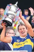  ?? ?? (Pic: INPHO/Ryan Byrne) Tipperary’s Karen Kennedy lifts the trophy following the Very Camogie League Division 1A final.