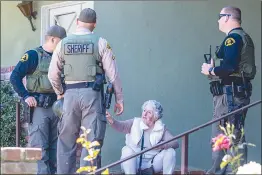  ?? Chris Torres/The Signal ?? (Left) Santa Clarita Valley Sheriff’s Station deputies respond to a report of an assault with a deadly weapon at The California­n Apartments on the 24000 block of Newhall Avenue early Friday afternoon. (Right) Deputies speak to a witness after responding to a report of an assault with a deadly weapon.