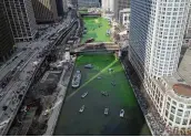  ?? ERIN HOOLEY / AP ?? The Chicago River is dyed green ahead of St. Patrick’s Day celebratio­ns Saturday in Chicago — among the most famous in America.