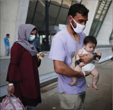  ??  ?? Refugees at Dulles Internatio­nal Airport in Virginia after being evacuated from Kabul