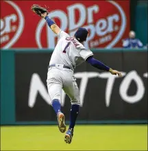  ?? PHOTOS BY RON JENKINS / GETTY IMAGES ?? LEFT: Jared Hoying of the Rangers isn’t able to make the catch on a ball hit to the wall by Houston’s Evan Gattis during the top of the first inning Sunday at Globe Life Park in Arlington. RIGHT: Houston’s Carlos Correa snags a fly ball off the bat of...