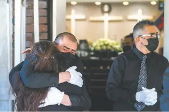  ?? Nic Coury / Special to The Chronicle ?? Friends and family mourn Carmelita Martinez outside Pastor El Buen church in San Jose. Martinez, a longtime school lunch lady lost to the coronaviru­s, leaves a loving legacy.