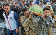  ??  ?? Tragic: Soldiers carry a body in Pole-Zahab,