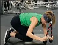  ?? (Arkansas Democrat-Gazette/Kimberly Dishongh) ?? Lisa Cooper, fitness director at the Little Rock Athletic Club, demonstrat­es the Diagonal Cable Crunch