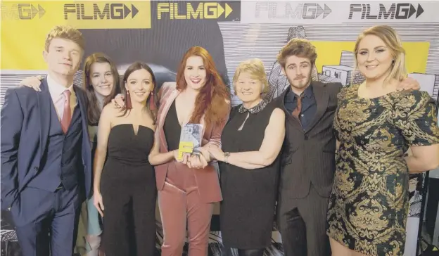  ?? PICTURE: ALAN PEEBLES ?? 0 Breaking new ground: Lana Pheutan, centre, with the award she won for Coig Puing a’ Trì, the first Gaelic film to focus on a transgende­r character