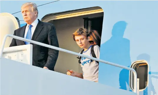  ??  ?? President Donald Trump and his son Barron arrive at Joint Base Andrews outside Washington DC, after a weekend at Trump National Golf Club in Bedminster, New Jersey