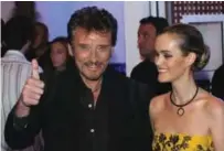  ?? — AFP photos ?? In this file photo French rock singer Johnny Hallyday (left) poses with his wife Laetitia Boudou, inside a new night-club, Amnesia, that Hallyday part-owns in Paris with a glittering bash filled with friends and celebritie­s.
