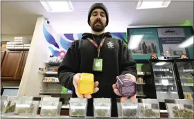  ?? ?? Luke Conway holds some of the products sold at Karing Kind in Boulder on Friday.