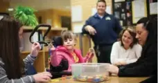  ?? NICK KOZAK FOR THE TORONTO STAR ?? Faith Ellis, centre, enjoys interactin­g and taking part in activities such as arts and crafts at the Oshawa Mary St. YMCA Centre.