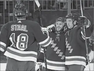  ?? BILL KOSTROUN/AP PHOTO ?? Rangers center Paul Carey (28) celebrates his goal with Jimmy Vesey (26) and Marc Staal (18) during the second period of Tuesday’s game against the Ducks at Madison Square Garden in New York.