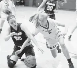  ?? JOSHUA MCKERROW/CAPITAL GAZETTE ?? Severna Park's Jess Albert and St. Marys' Karry Keliher collide over a loose ball in the girls basketball game at St. Marys.