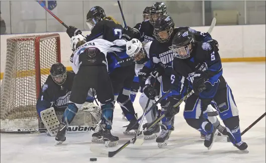  ?? STEVEN MAH/SOUTHWEST BOOSTER ?? Wildcats’ defenseman Maddy Mccleary (right) skated the puck away from harm’s way during a 2-1 overtime win on Sunday.