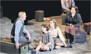  ?? — AFP photo ?? Cast members sit within a concrete Star of David divided into sections representi­ng the rooms in the ‘secret annex’ where the Frank family and four others hid for more than two years during the theatrical production of ‘Je Anne’ (‘Yours, Anne’) based on Anne Frank’s diaries, which returned to the stage at the Kennemer Theater, Beverwijk, near Amsterdam.