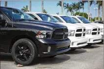  ?? JOE RAEDLE / GETTY IMAGES ?? The federal government claims Fiat Chrysler cheated on emissions tests of diesel engines in Ram pickups and Jeep Grand Cherokees for the 2014-16 model years. At left, new Rams sit on a lot Tuesday in Miami.