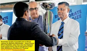  ?? PIX BY DAMITH WICKRAMASI­NGHE ?? Ranil Dias Trophy is handed over to Royal captain by Ekendra Edirisingh­e – Asian Games Silver Medallist, after they won the Optimist team racing event. Also in the picture is Rev Marc Billimoria, Warden of S. Thomas’