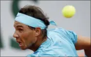  ?? ALESSANDRA TARANTINO — THE ASSOCIATED PRESS ?? Spain’s Rafael Nadal returns a ball to France’s Richard Gasquet during their third round match of the French Open tennis tournament at the Roland Garros stadium, Saturday in Paris.